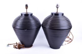 A pair of contemporary 'Val Sens du Faits' table lamps. Black ceramic body of ribbed baluster form.
