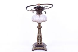 A brass and glass oil lamp, no shade.