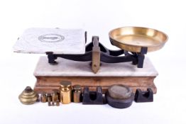 A set of vintage Bartlett & Son Ltd marble and brass balance shop scales with some weights.