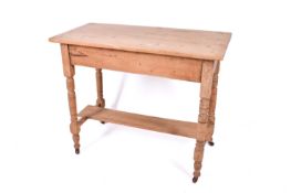 A Victorian pine washstand. Having turned supports united by stretcher and under shelf.