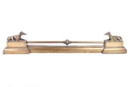 Brass fire fender with greyhound finials.