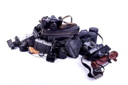 Collection of assorted vintage cameras and photographic equipment.