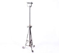 A black painted wrought iron standard lamp