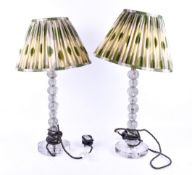 A pair of contemporary seeded glass table lamps. Raised on circular bases.