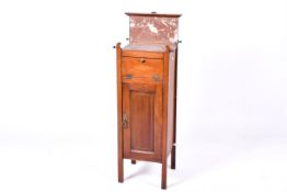 An Edwardian mahogany inlaid shaving stand with a marble top.