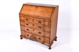 A 20th century Queen Anne Style walnut veneer bureau.
