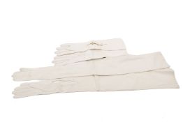 Two pairs of women's white kid leather long evening gloves.