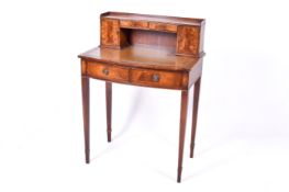 A 20th century Regency style ladies bow fronted writing desk.