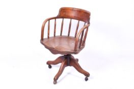 An Edwardian oak swivel desk chair.