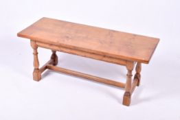 An oak rectangular coffee table. Raised on turned ring baluster supports united with stretchers.