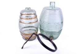 Two vintage ribbed glass barrels.