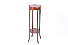 An Edwardian mahogany jardiniere stand. Having a circular inlaid top.