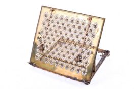 A brass easel back book stand. Having pierced decoration.