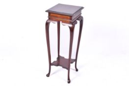 An Edwardian mahogany jardiniere stand. Having cabriole supports united by lower tier.