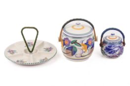 Three mid-century Poole Pottery tableware items with cane handles.