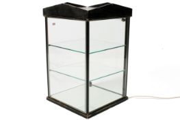 A shop counter-top illuminated glass display cabinet.
