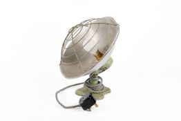 A mid-century electric heater converted to a table lamp. Having a cast metal quatrefoil base.