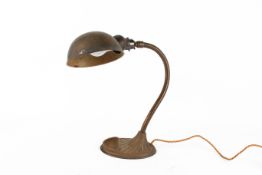 An early 20th century 'Supreme' adjustable goose neck desk lamp, with cast metal oval base.