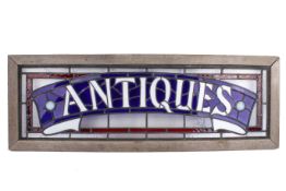 'Antiques' leaded stained glass window panel, framed. Total 98cm x 34.