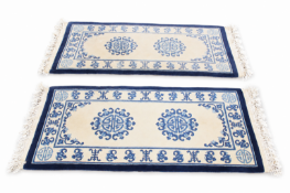 A pair of short Chinese runner rugs.