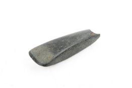 A possibly Oceanic polished green stone axe head.