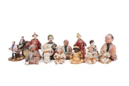 A collection of 20th century Japanese nodding stoneware model figures.
