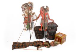 A group of Asian collectables. Including Thai shadow puppets, a plaster mask, etc.