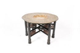 A large Middle Eastern brass tray and folding stand.