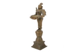 An Indian bronze of a Lakshmi oil lamp, possibly 19th century.