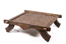 An antique Indian rustic ox or camel cart platform adapted as a low table on four out-swept feet