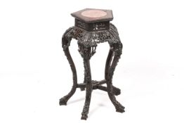 A late 19th/early 20th century Chinese carved wood vase stand.