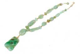 A Chinese apple green jadeite pendant.