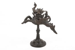 An Indian bronze model of the mythological animal yali. Raised on a spread base, H14.3cm.