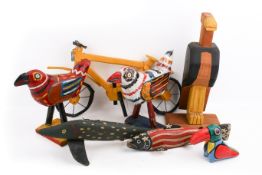 A group of folk art painted wood and pottery items.