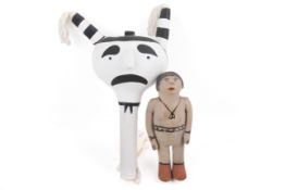A Cochiti storyteller doll and a Hopi gourd rattle. The first of painted clay, H15.