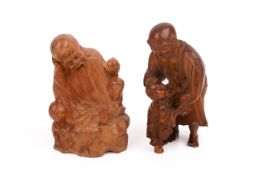 Two Japanese wood carvings of figures.