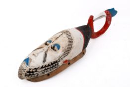 A Baule tribal hand carved African mask, Ivory Coast. With white face and blue and red features.