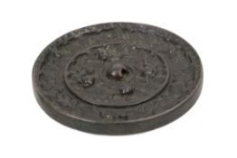 A Tang Dynasty style Chinese 'lion and grapevine' bronze mirror.