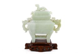 A 20th century Chinese pale green jade incense burner with wooden stand.