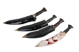 Four vintage kukri knives with scabbards. Three with horn handles, blade length circa 24cm.