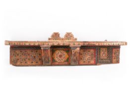 An Indian painted wall shelf. Decorated with flowers and geometric patterns, H20cm x W70cm.