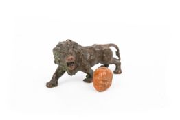 A Japanese small bronze model of a lion.
