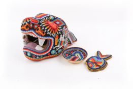 A Mexican Huichol beadwork jaguar head and two other small pieces.