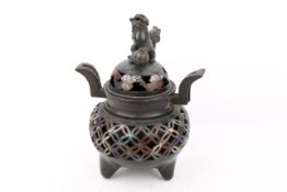 An early 20th century large bronze Chinese incense burner with dog of Foo finial.