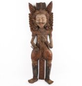 A Thai carved wood wall figure of a deity.