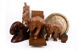 A collection of assorted carved wood or metalware items.
