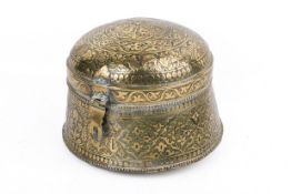 A Middle Eastern brass spice container.