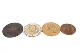 Four bronze and enamel medallions.