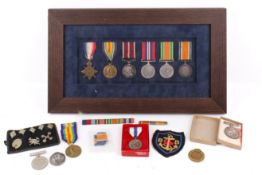 An assortment of WWI and WWII medals and collectables and a unniform.