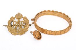 A Trench Art armband, a badge and a button.